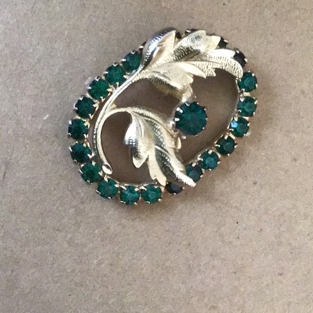Lovely pin / brooch .  Gold tone with green stones.  Well made. Vintage?